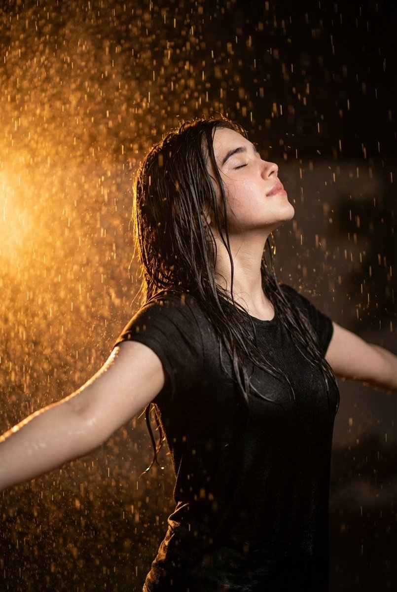 Cinematic portrait of woman in heavy rain at night — example 1