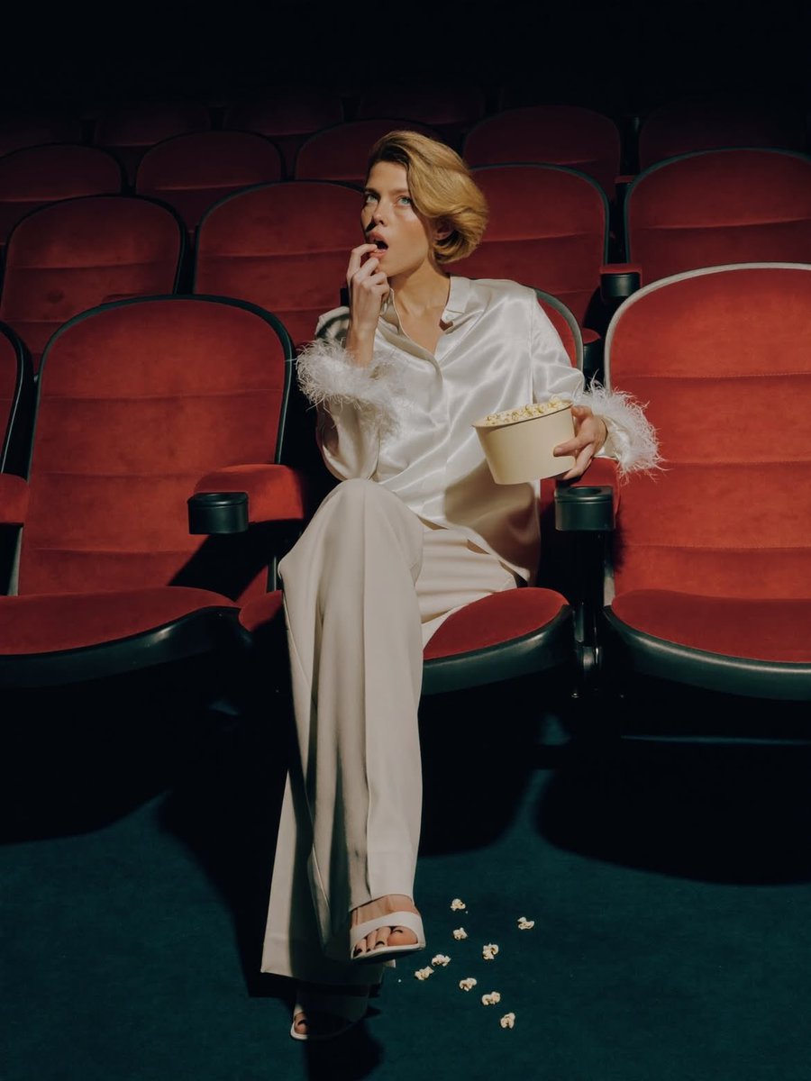 Elegant Fashion Editorial in a Dark Movie Theater — example 1