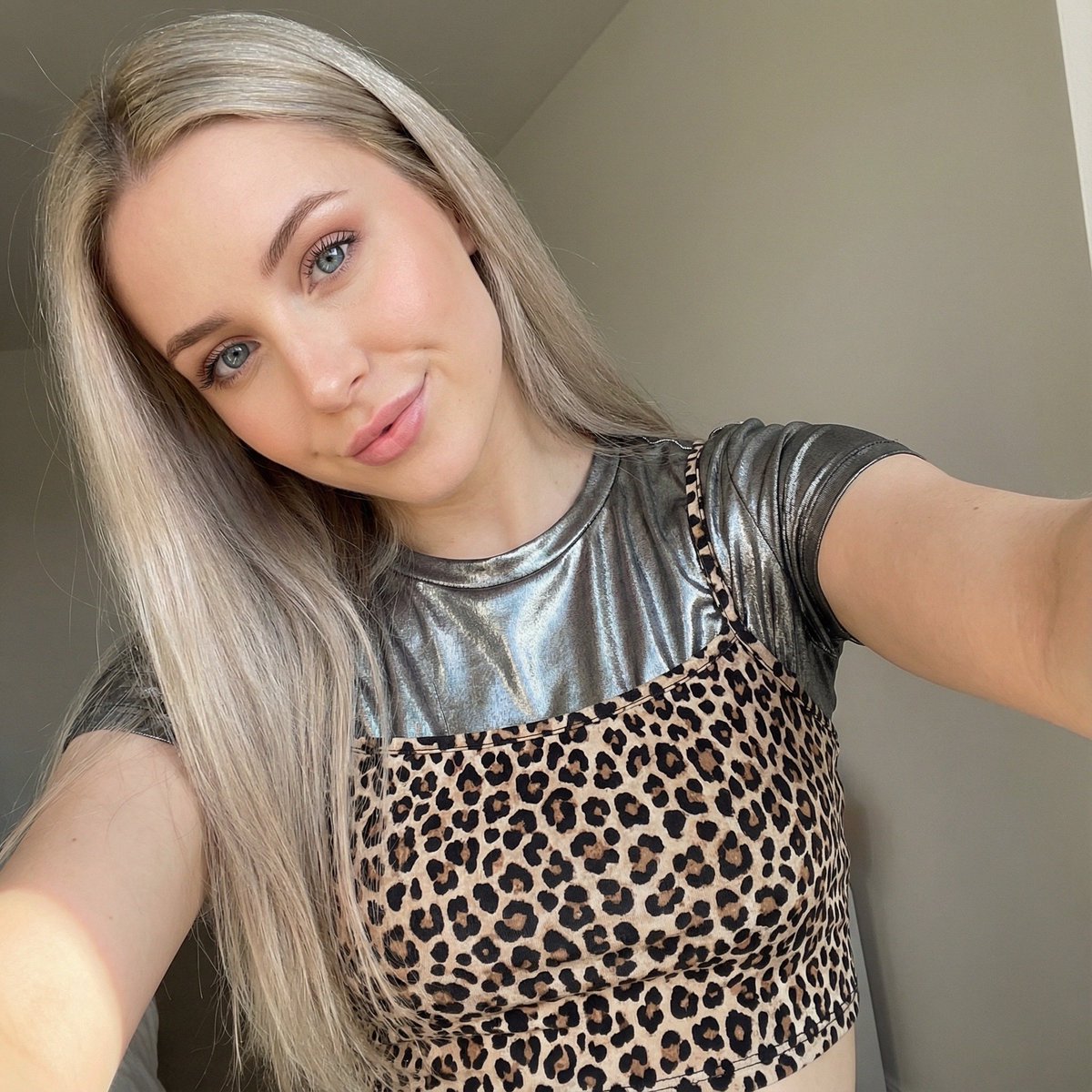 Close-up Selfie of a Woman in Leopard Print and Metallic Shirt — example 2