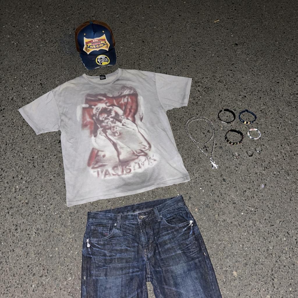 Clothing items laid out on asphalt — example 2