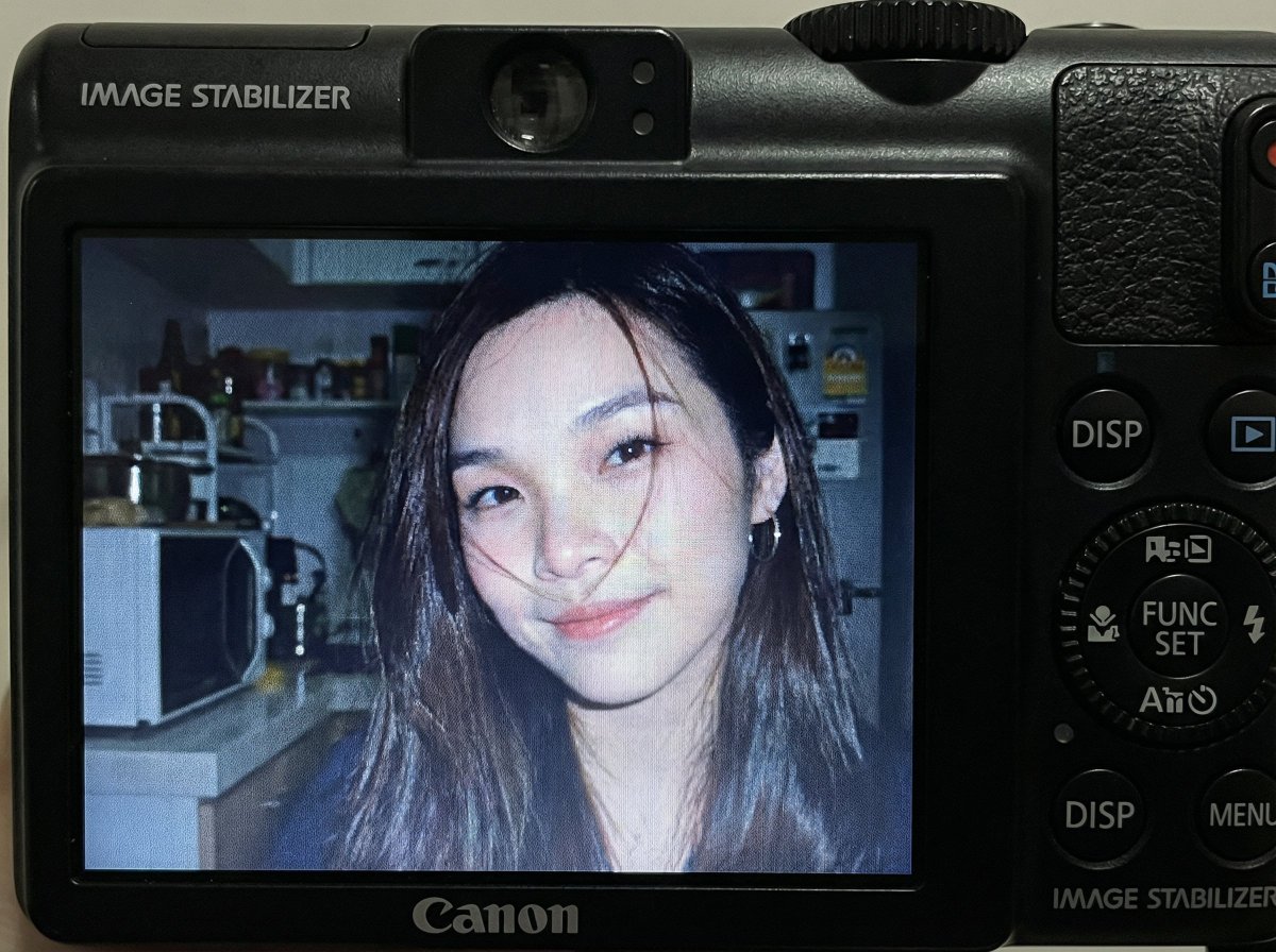 Compact Digital Camera Screen Snapshot of a Young Woman — example 1